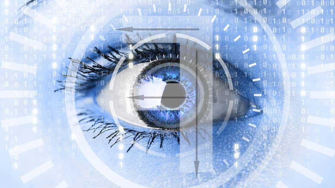 A human eye superimposed on a blue background of ones and zeros and a letter F